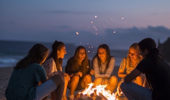 Group of female friends are saying some jokes to each other