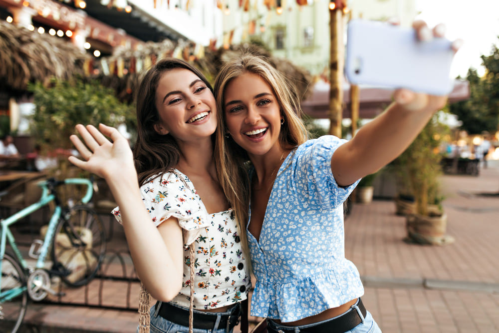 two beautiful female friends taking selfie 