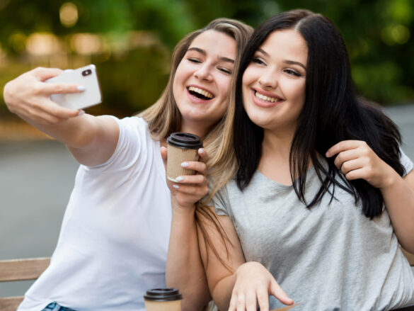 two female friends taking selfie 